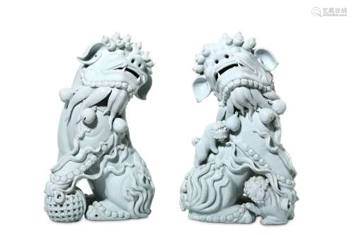 A PAIR OF CHINESE BLANC-DE-CHINE LION DOGS. 20th Century. Finely modelled, seated, facing opposite