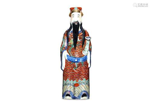 A CHINESE FAMILLE ROSE FIGURE OF AN OFFICIAL. Qing Dynasty. Standing, wearing an iron-red dragon