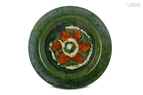 A CHINESE SANCAI DISH. Tang Dynasty. Incised to the centre with a stylised flower head, 23cm
