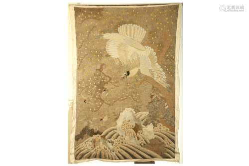 AN EMBROIDERED HANGING. Meiji period. Densely worked in various stitches, with an eagle attacking
