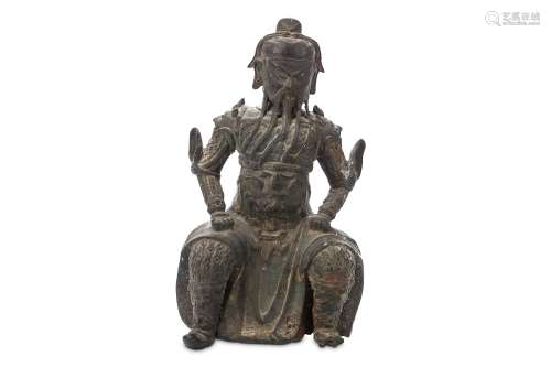 A CHINESE BRONZE FIGURE OF GUANDI. Ming Dynasty. Seated in full armour, the legs wide and hands
