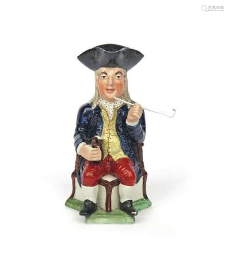 A Squire Toby jug c.1810 20, seated on a corner ch...;