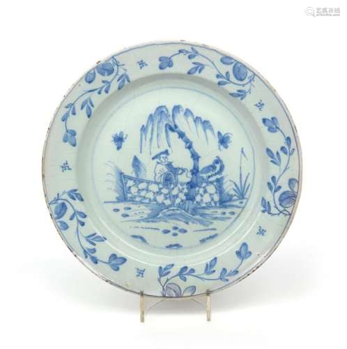 A large delftware charger c.1760, painted in blue ...;