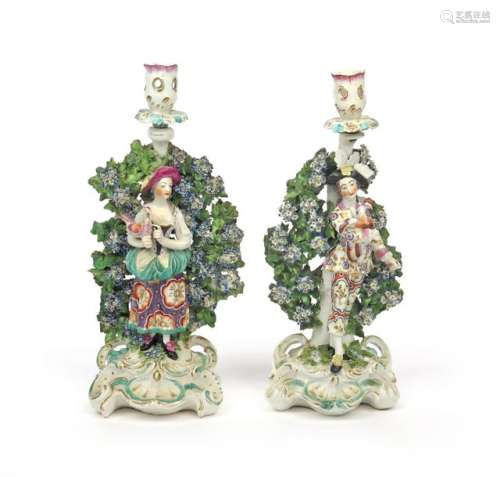 A pair of Derby candlestick figures of the Italian...;