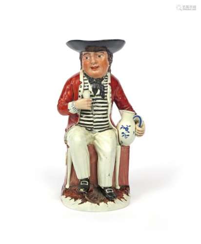A Sailor Toby jug c.1800 10, seated on his sea che...;