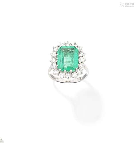 An emerald and diamond cluster ring