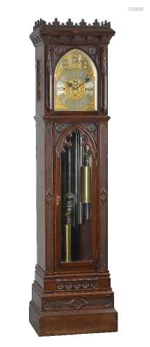 An impressive late Victorian Gothic revival carved mahogany quarter-chiming longcase regulator