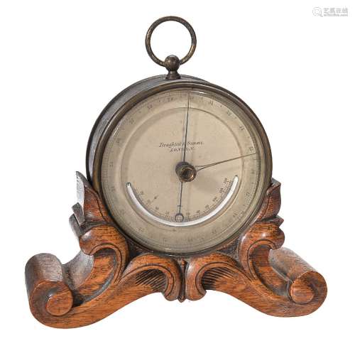 A brass aneroid desk barometer with thermometer