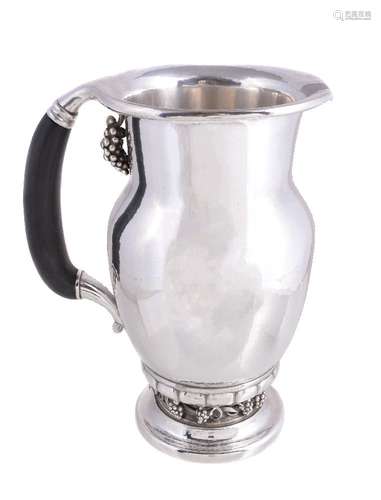 ϒ Georg Jensen, a Danish silver Grape pattern pitcher or jug