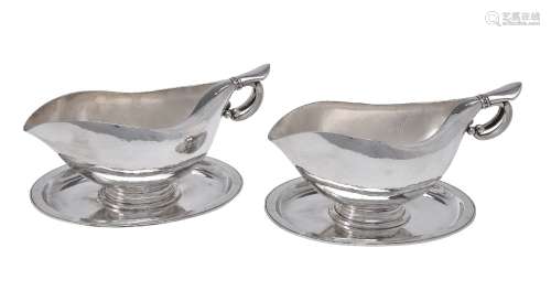 Georg Jensen, a pair of Danish silver sauce or gravy boats on integral stands