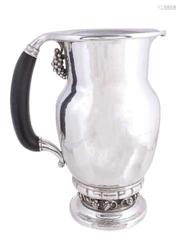 ϒ Georg Jensen, a Danish silver Grape pattern pitcher or jug