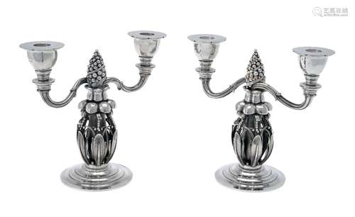 Georg Jensen, a pair of Danish silver Fir Cone twin light candelabra