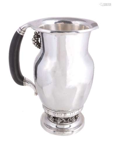 ϒ Georg Jensen, a Danish silver Grape pattern pitcher or jug