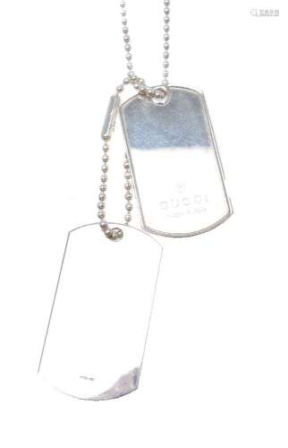 A silver coloured dog tag necklace by Gucci