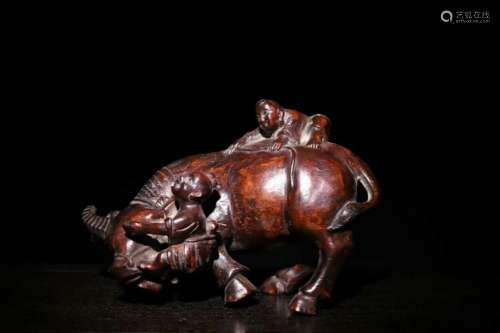 A CARVED CHENXIANG WOOD CATTLE WITH CHILDREN