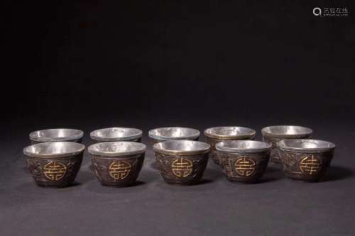 A SET OF COCONUT CUPS WITH SILVER MOUNT