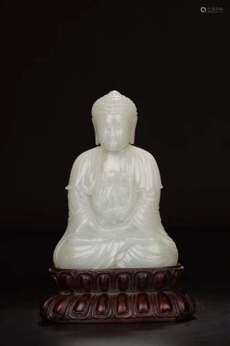 A HETIAN JADE FIGURE OF SHAKYAMUNI