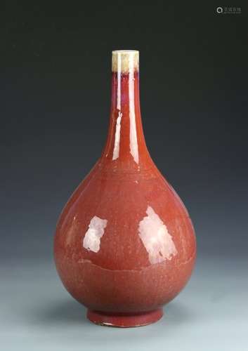 AN OXBLOOD BOTTLE VASE WITH  BULBOUS BODY