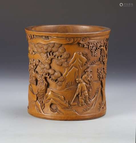 A WOODEN CARVED BRUSH POT