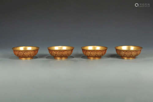 AN OLD FLORIAL DESIGN GILT BRONZE BOWLS