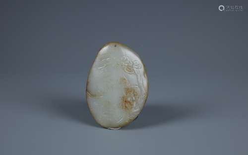 A FINELY CARVED WHITE AND RUSSET JADE BOULDER WITH