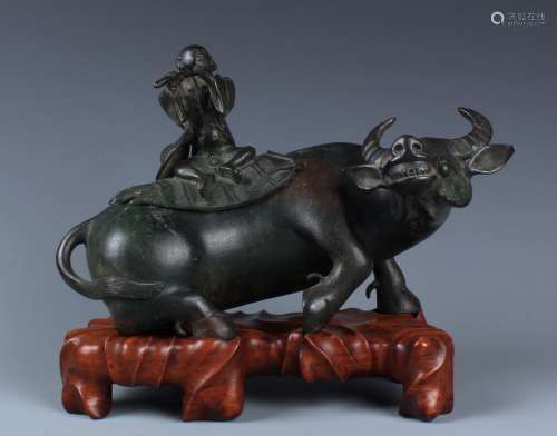 AN UNUSUAL BRONZED CARVED BOY AND BUFFALO INCENSE