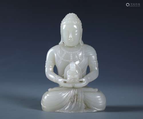 A CARVED CHINESE WHITE JADE FIGURE OF SAKYAMMUNI