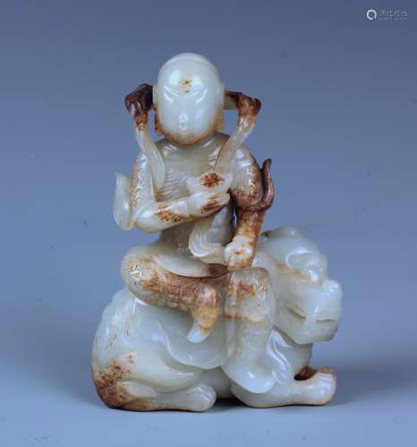 A FINELY CARVED CHINESE WHITE AND RUSSET JADE