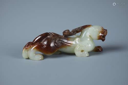 A Carved Celadon and Russet Jade Tiger Pendant