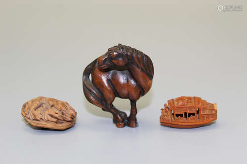 Three Asian wood and nut carvings.