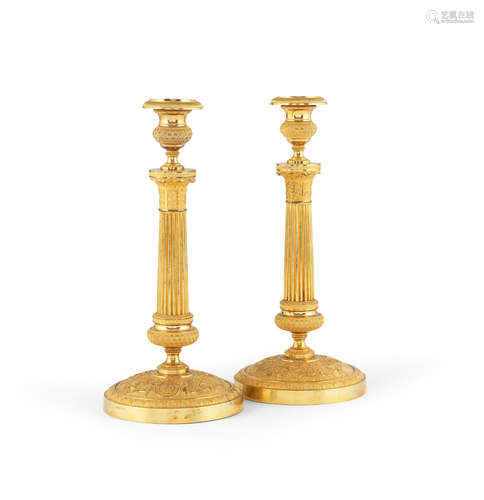 A pair of French early 19th century gilt bronze candlesticks