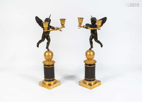 A pair of French 19th century bronze candelabra modelled as Cupid and his bow