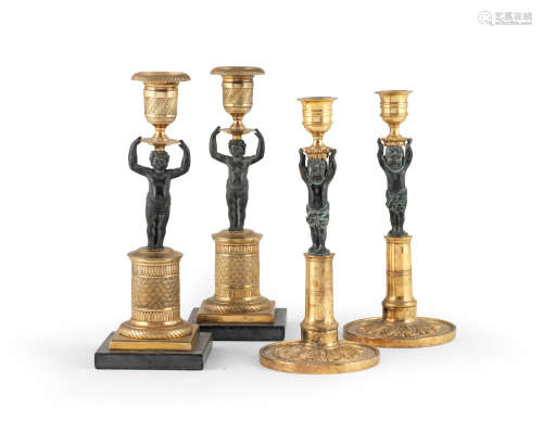 Two pairs of French late 19th / first half 20th century patinated and gilt bronze candlesticks