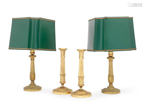 A pair of French late 19th/ early 20th century gilt bronze candlesticks adapted to lamp bases