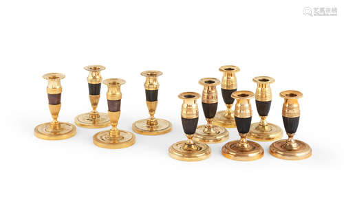 Five pairs of small 19th century patinated and gilt-bronze candlesticks