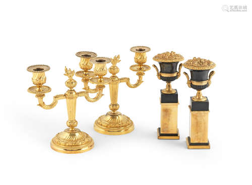 A pair of French late 19th century gilt-bronze twin branch candelabra, together with a pair of gilt and patinated bronze floral filled campagna urns