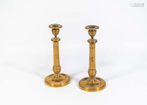 A pair of French early 19th century gilt-bronze candlesticks