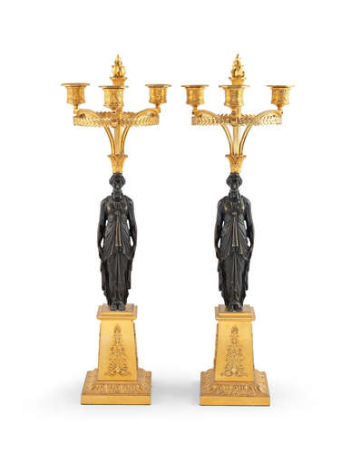 In the manner of Pierre-Philippe Thomire (1751–1843) A pair of French 19th century gilt and patinated bronze three-light candelabra