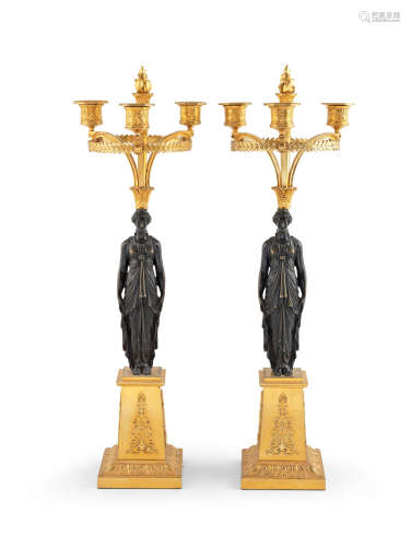In the manner of Pierre-Philippe Thomire (1751–1843) A pair of French 19th century gilt and patinated bronze three-light candelabra