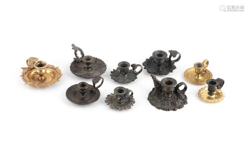 19th century  A collection of nine French bronze, gilt-bronze and brass miniature chamber sticks