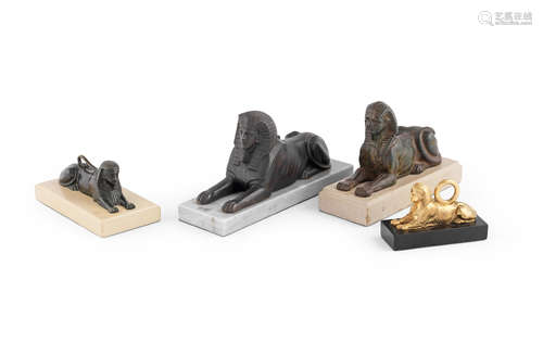 A group of four figures of sphinx