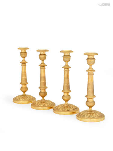 A set of four French gilt bronze candlesticks