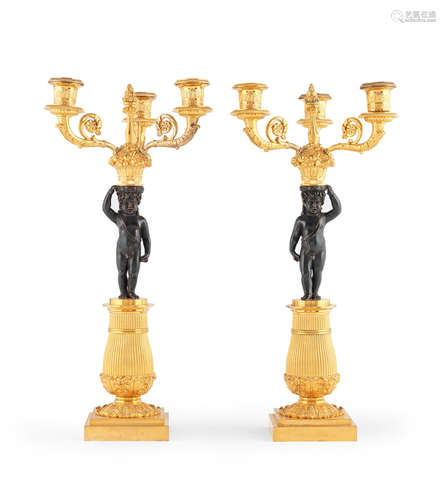 Probably Restoration A pair of French early 19th century gilt and patinated bronze three branch candelabra