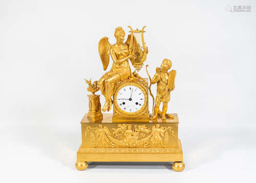 An early nineteenth century gilt bronze clock depicting an Allegorical scene