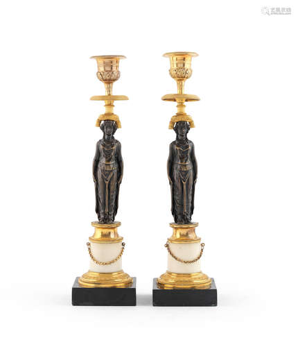 A pair of French 19th century gilt and patinated bronze candlesticks