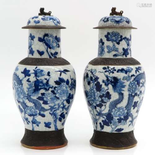 A Pair of Stoneware Vases with Covers