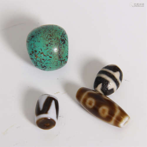 THREE TIBETAN DZI BEADS AND ONE TURQUOISE BEAD