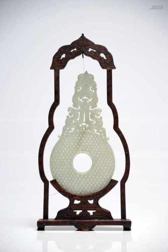 Chinese Jade Bi in wood frameWhite JadeChinaH: 30 cm This delicately carved jade bi comes in a