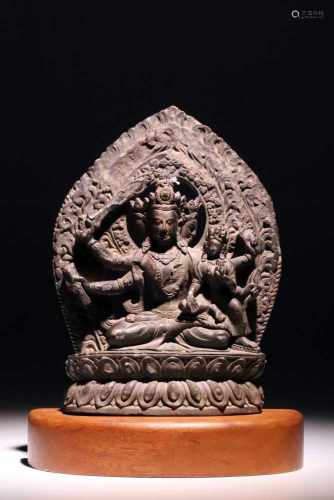 ManjushriStoneNepal16th ctH: 25 cmA three-headed Manjushri statue on a wooden platform. The deity is