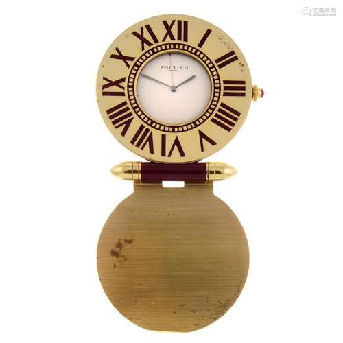 A travel clock by Cartier. Gold plated case with